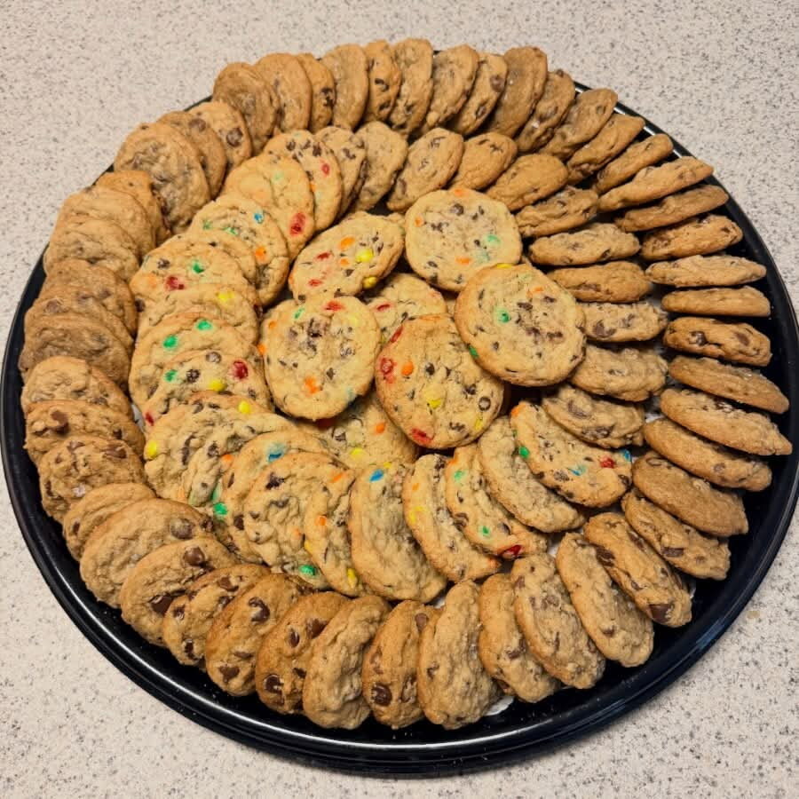 Party tray filled with chocolate chip and candy cookies.